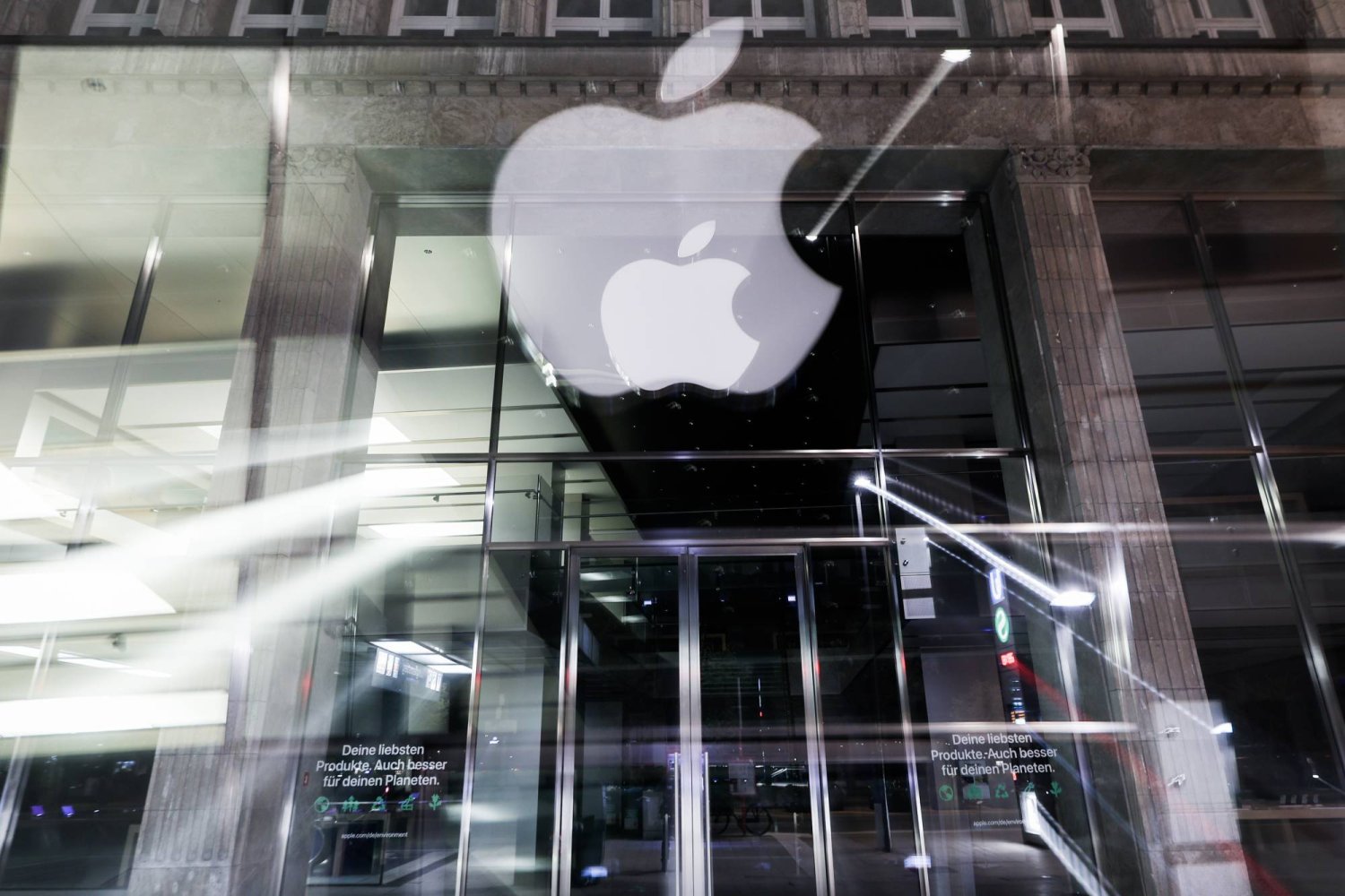 FILED - 01 May 2023, Hamburg: The logo of the US technology company Apple can be seen at night at the Apple Store Jungfernstieg in the city center. Photo: Christian Charisius/dpa