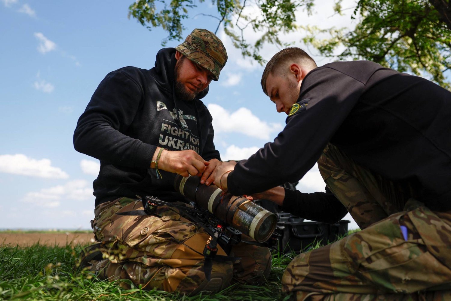 A Ukrainian serviceman of the 28th Separate Mechanised Brigade with the call sign 'Sokil' (Falcon) and his brother-in-arms prepare an FPV (first person view) drone for a test flight at a training ground, amid Russia's attack on Ukraine, in Donetsk Region, Ukraine May 3, 2024. REUTERS/Valentyn Ogirenko