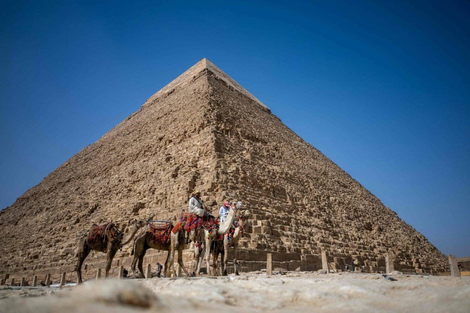 Camel riders are seen at the foot of Khafre Pyramid in Giza, south of the Egyptian capital. (AFP) 