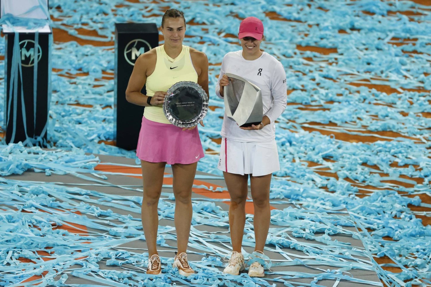 Iga Swiatek (R) of Poland poses with her trophy after winning the women's singles final match against Aryna Sabalenka (L) of Belarus at the Madrid Open tennis tournament in Madrid, Spain, 04 May 2024.  EPA/CHEMA MOYA