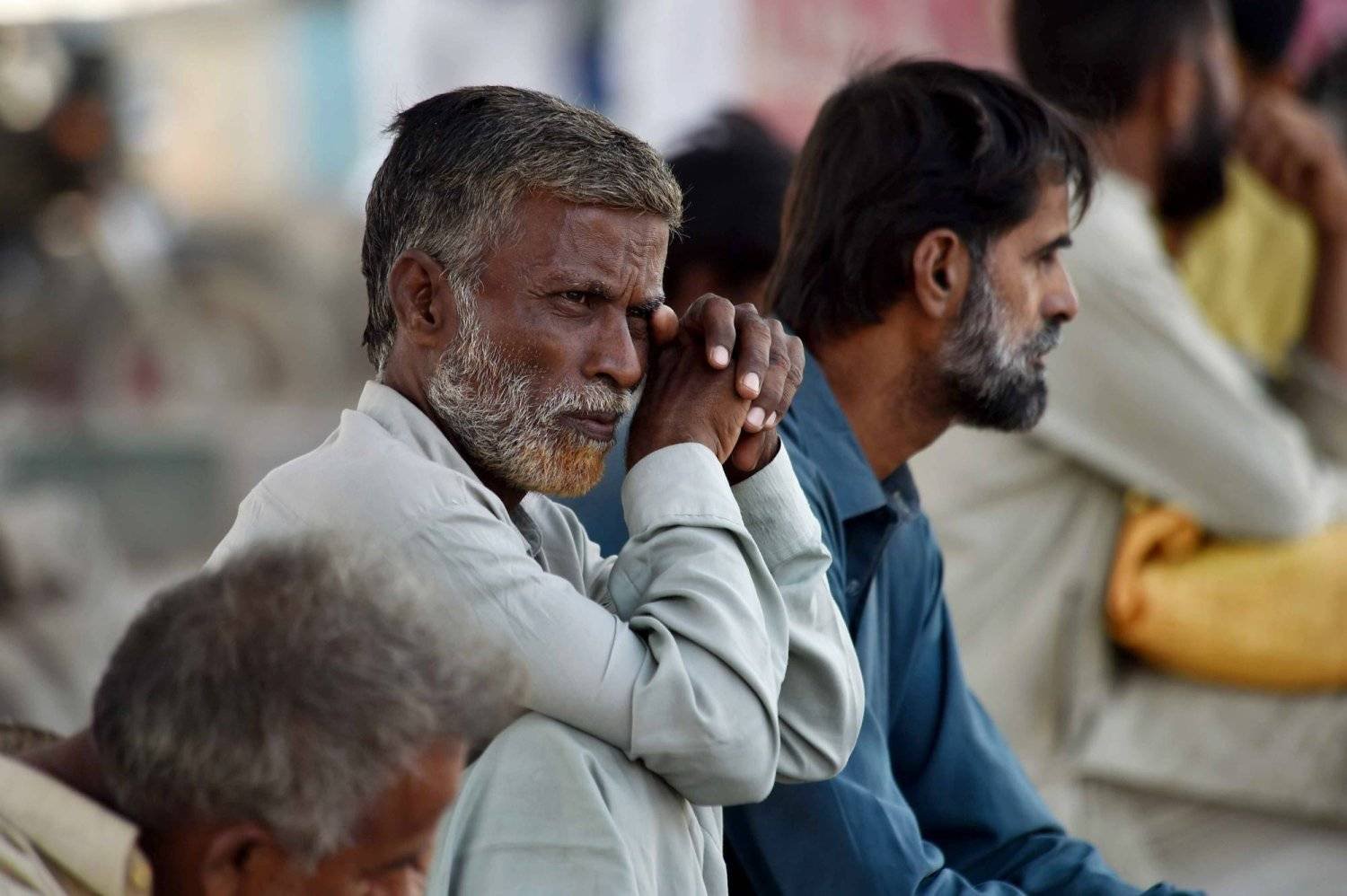 Laborers who work on daily wages wait to get hired in Karachi, Pakistan, (EPA)

