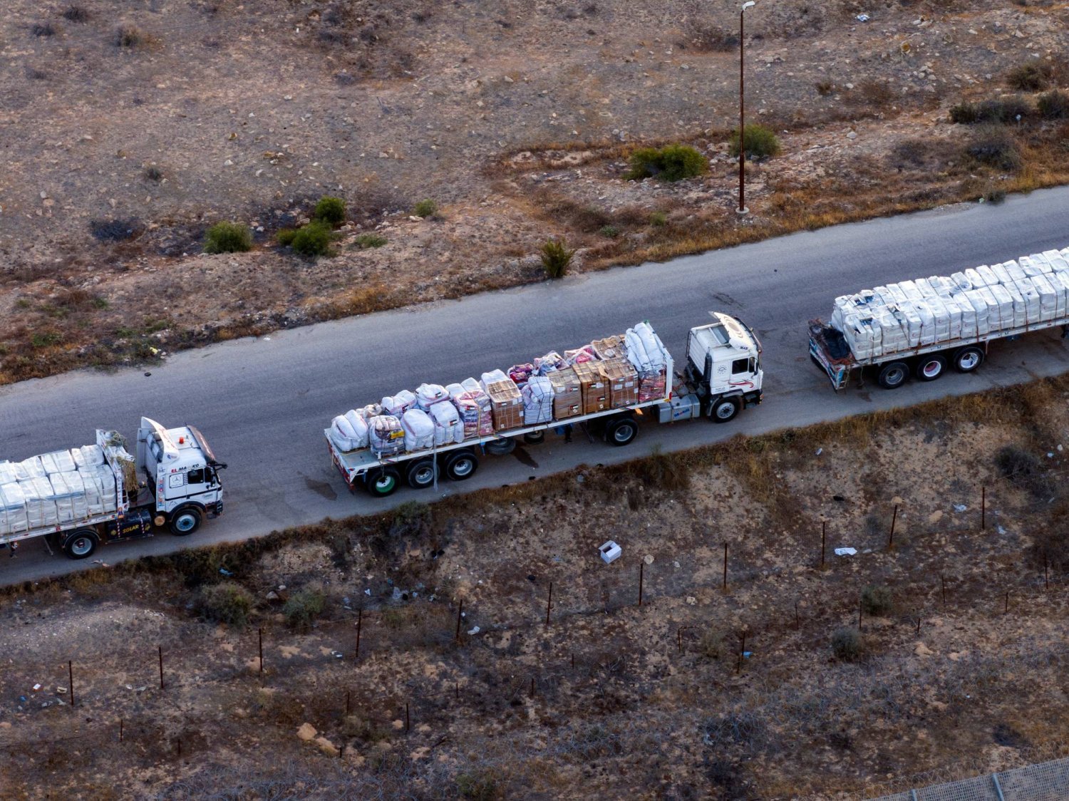 A drone picture of part of a line of trucks waiting on an Egyptian road along the border with Israel, near the Rafah border crossing with the Gaza Strip May 2, 2024. REUTERS/Oren Alon