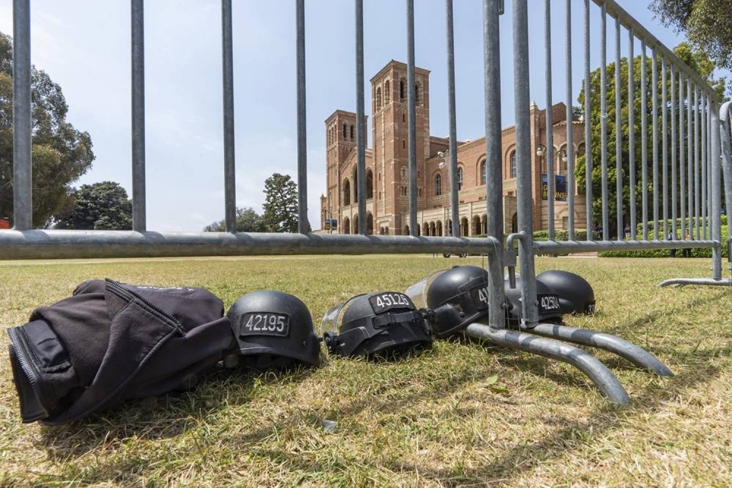 Police riot gear lays on the grass next to steel barriers set up outside Royce Hall at the UCLA campus in Los Angeles on Friday, May 3, 2024. (AP)