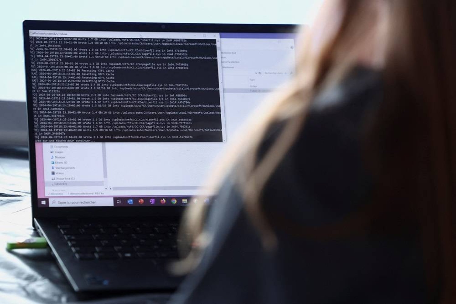  A cybersecurity employee from the Paris 2024 flying squad manages a simulated cyber attack and pretends to resolve it from a computer on the Olympic site which will host the hockey events at Yves-du-Manoir Stadium in Colombes, near Paris, France, May 3, 2024. (Reuters)