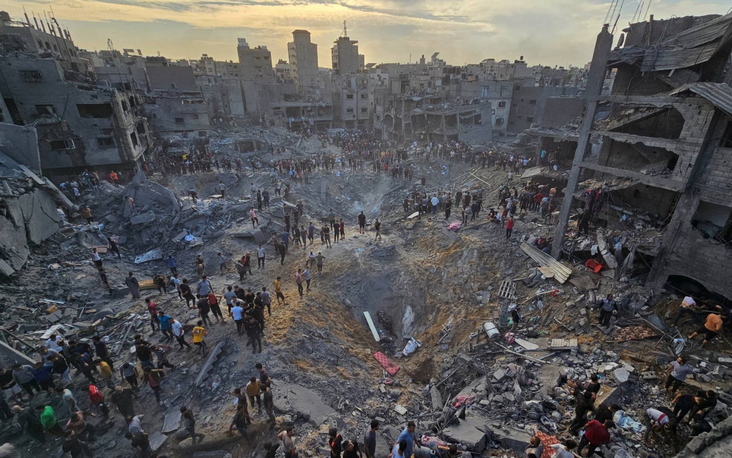 Palestinians search for casualties amid deep craters filled with broken concrete and twisted metal, after Israeli air strikes on the Jabalia refugee camp in the northern Gaza Strip, October 31, 2023.   REUTERS/Anas al-Shareef    