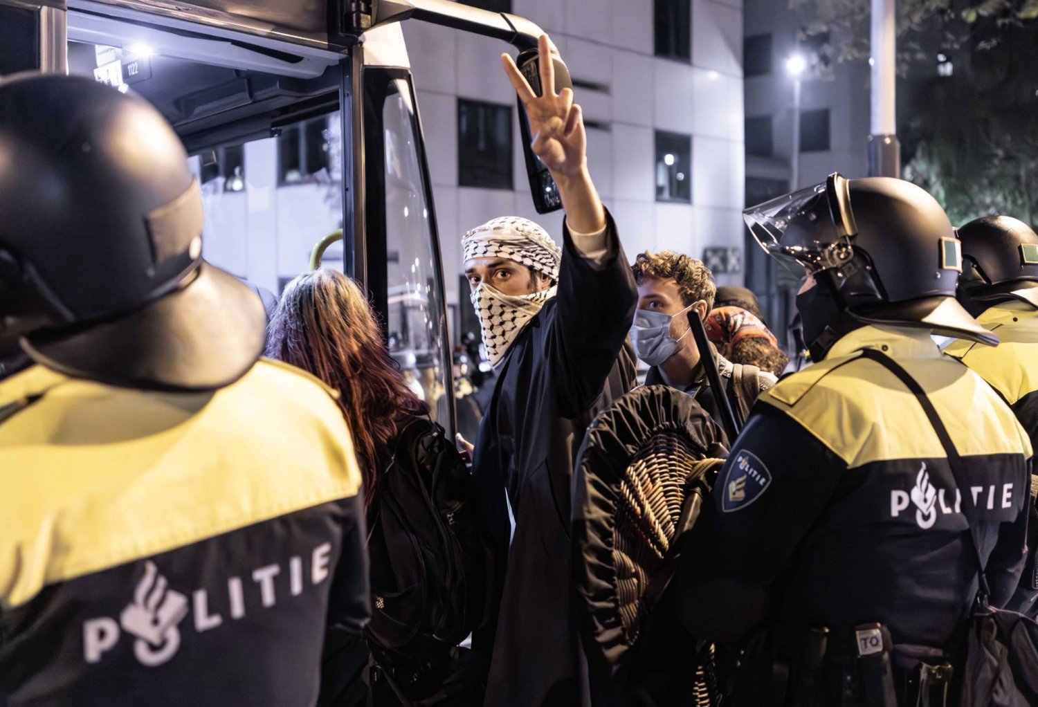 A protester (C) is escorted into a bus by police during a pro-Palestinian protest at the University of Amsterdam (UvA) campus in Amsterdam, Netherlands, 07 May 2024. EPA/EVA PLEVIER