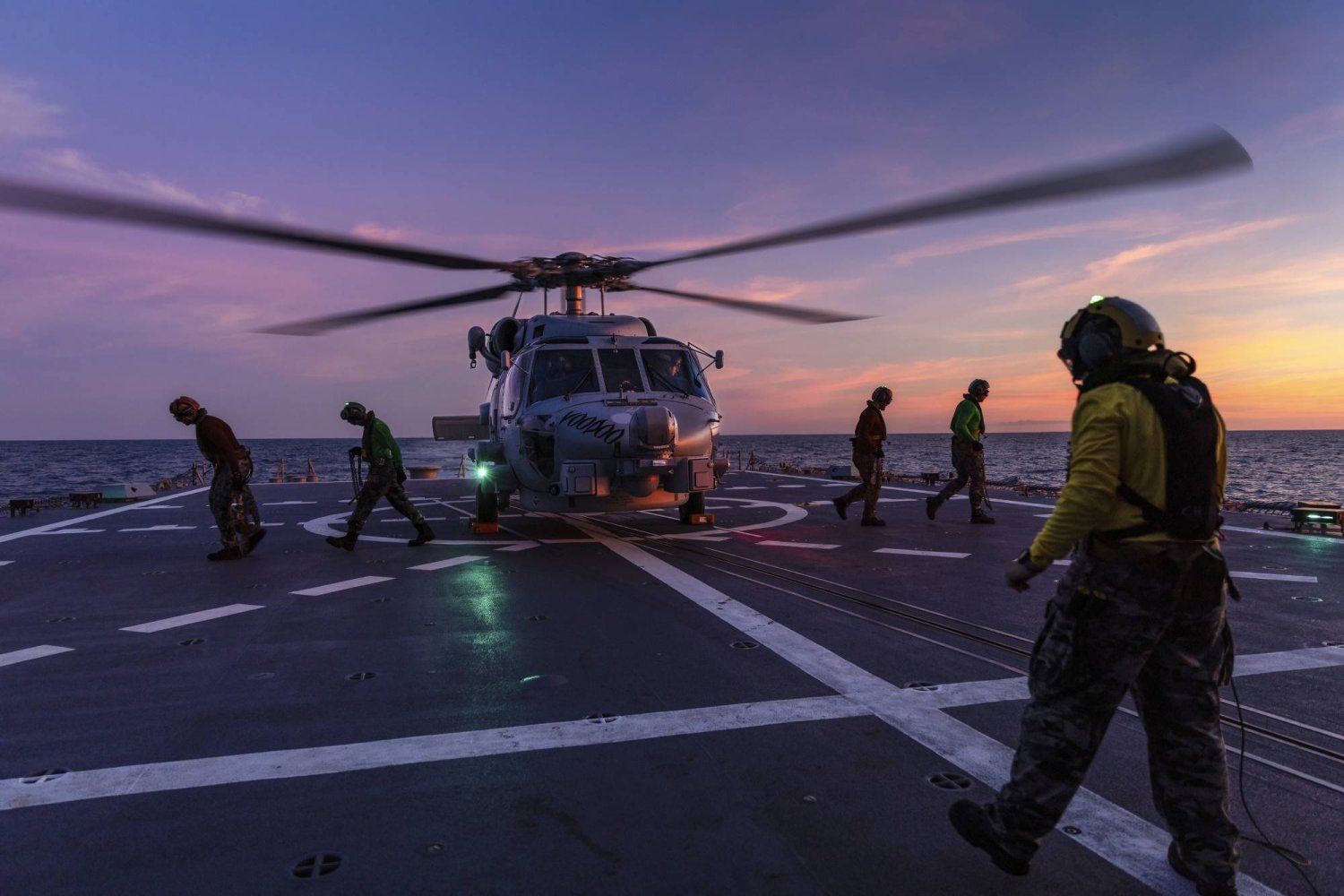 In this undated photo provided by the Australian Defense Force, a Seahawk helicopter prepares to take off from the deck of HMAS Hobart during flying operations while on a regional presence deployment off northern Australia. Australia has protested to Beijing through multiple channels that a Chinese fighter jet endangered an Australian navy helicopter with flares over international waters, the prime minister said Tuesday, May 7, 2024. (LSIS Matthew Lyall/Australian Defense Force via AP)