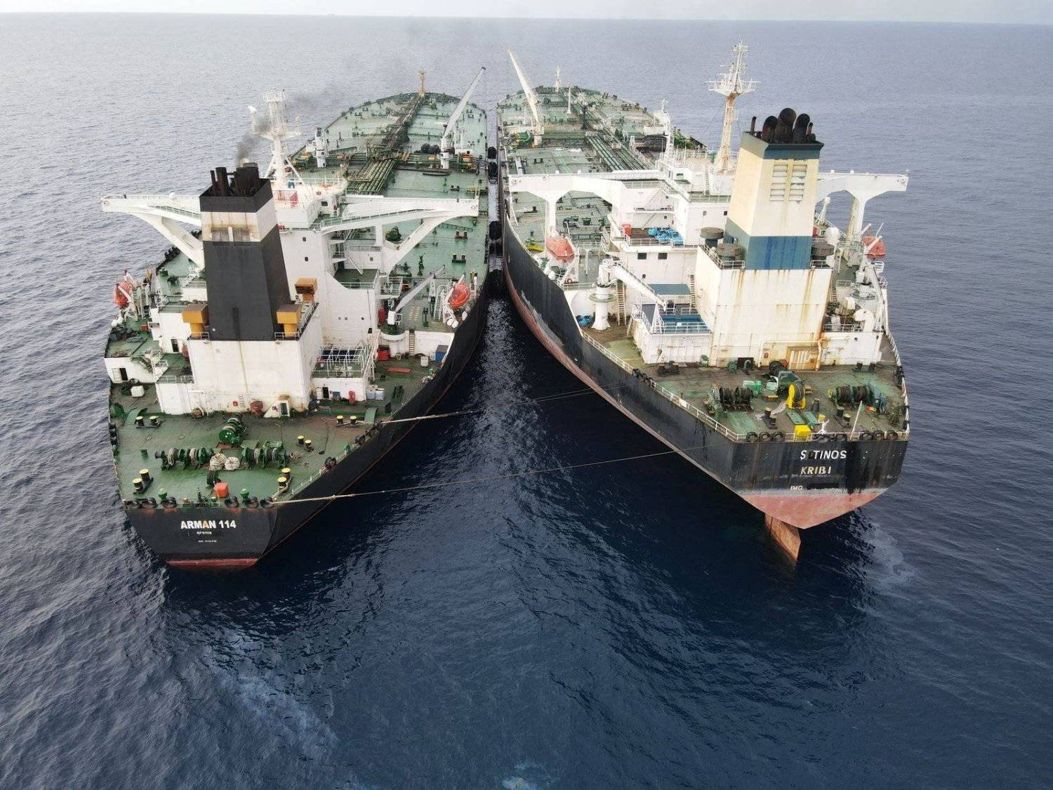 The Iranian-flagged Very Large Crude Carrier (VLCC), MT Arman 114, and the Cameroon-flagged MT S Tinos, are seen as they were spotted conducting a ship-to-ship oil transfer without a permit, according to Indonesia's Maritime Security Agency (Bakamla), near Indonesia's North Natuna Sea, Indonesia, July 7, 2023 in this handout picture released July 11, 2023. (Bakamla/Reuters) 
