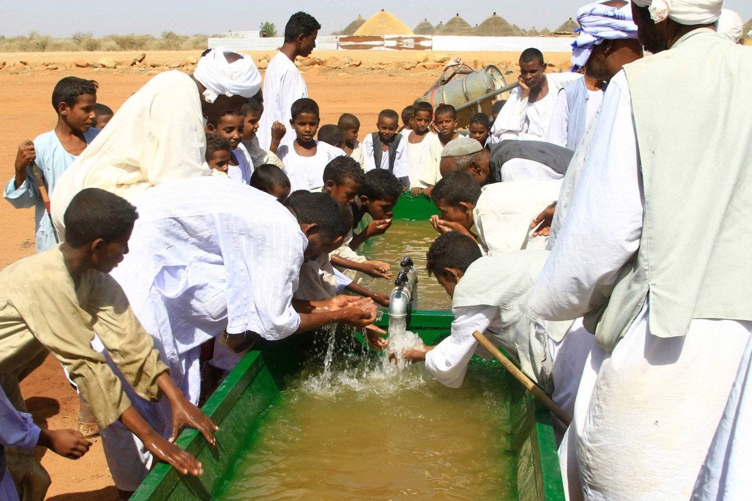 Sudanese drink from water extracted from an underground well in eastern Sudan. (AFP)  