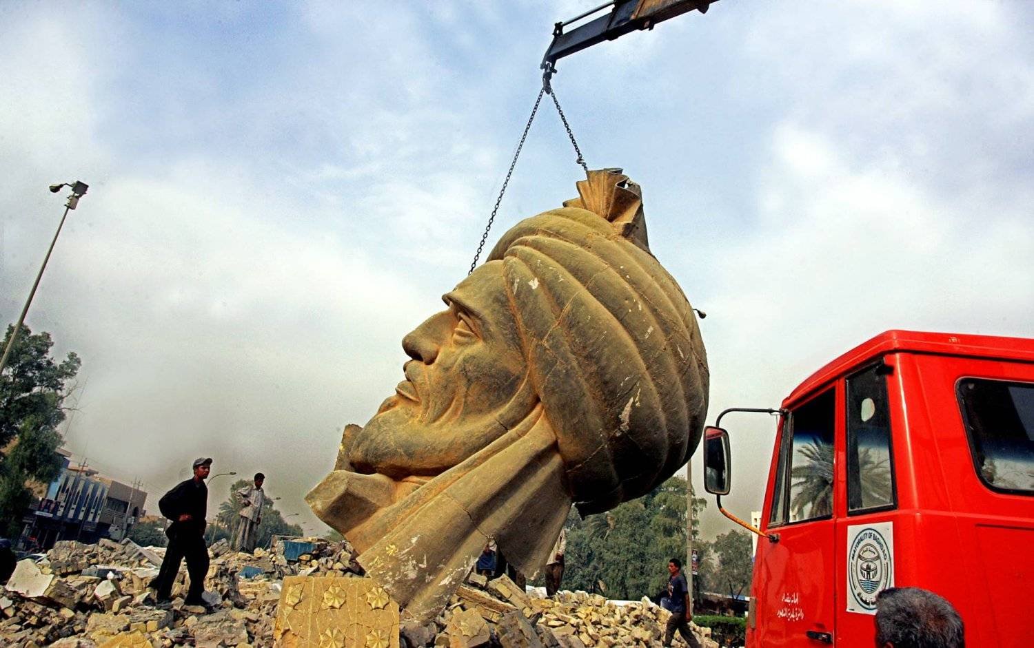A crane lifts the bust of Abu Jafar Al-Mansur from the site of an explosion that targeted it in 2005 (AFP)