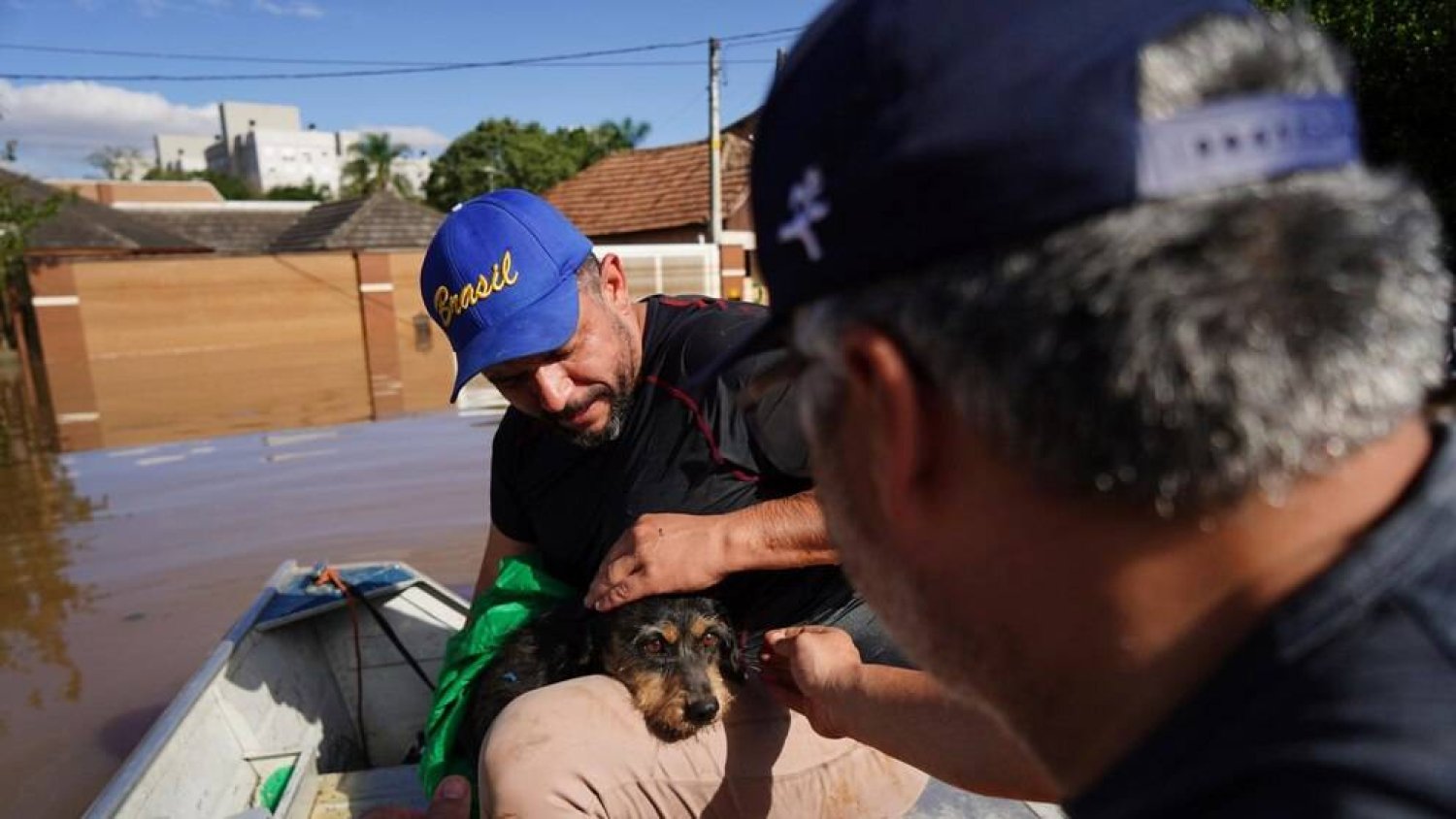 People rescue a dog named Maia from a flooded area after heavy rain in Canoas, Rio Grande do Sul state, Brazil, Thursday, May 9, 2024. (AP Photo/Carlos Macedo)
