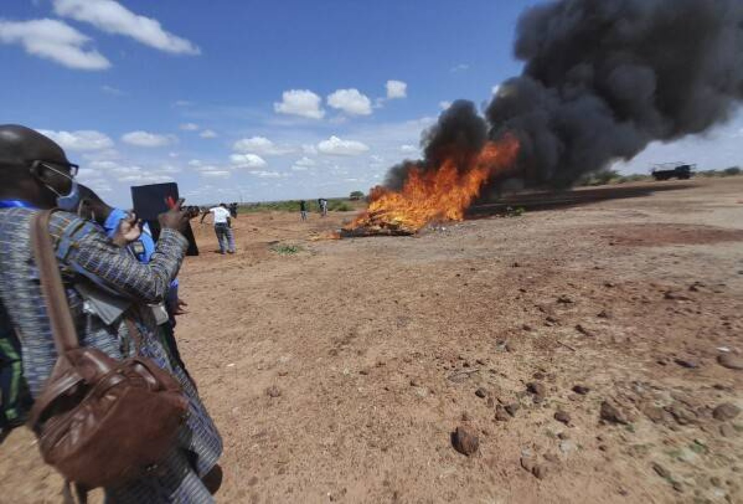 In this photo released by The United Nations Office on Drugs and Crime, shows officials burning seized drugs in Niamey, Niger, Monday, June 26, 2023. (UNODC via AP)