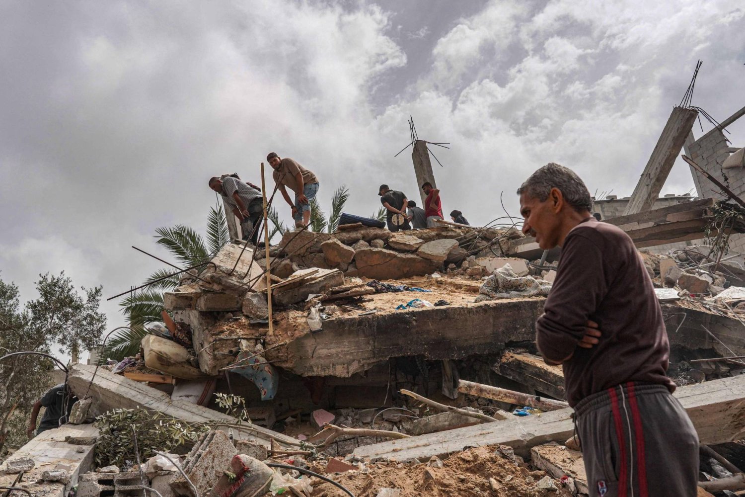 Palestinians check the rubble of a residential building destroyed in an Israeli strike in  Al-Zawayda in the central Gaza Strip on May 11, 2024. (Photo by AFP)