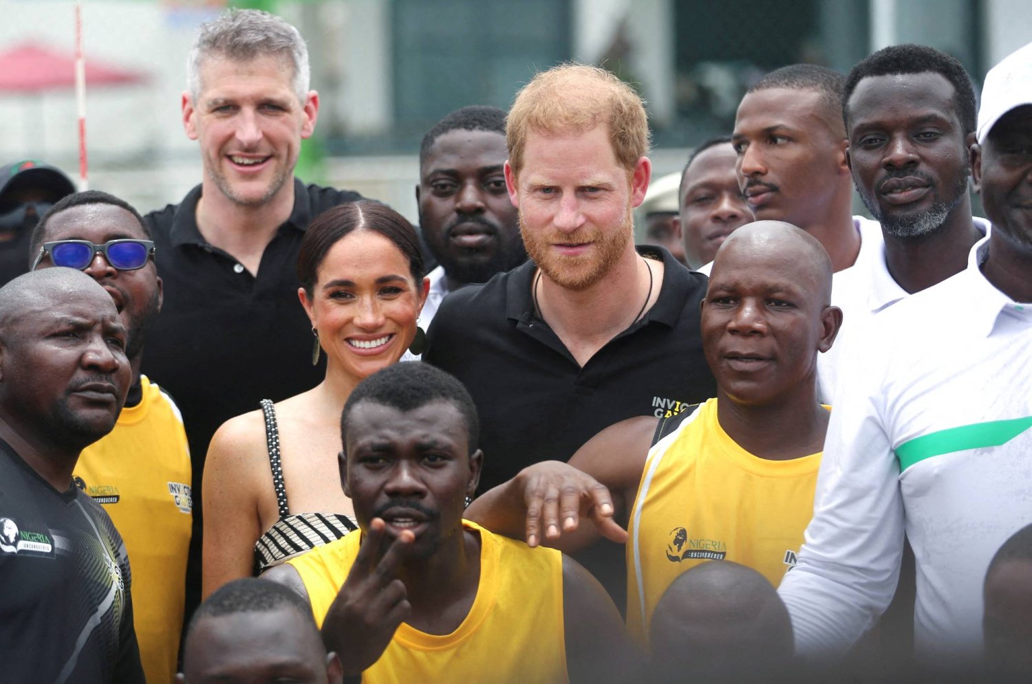 Britain's Prince Harry, Duke of Sussex and his wife Meghan, Duchess of Sussex pose on the day they attend a volleyball match played with wounded army veterans, at the Nigerian army officers' mess in Abuja, Nigeria May 11, 2024. REUTERS/Akintunde Akinleye