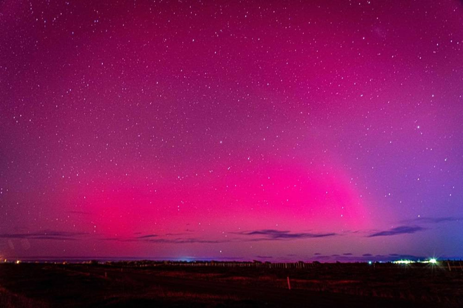 The Aurora Australis, also known as the Southern Lights, glow on the horizon over Punta Arenas, Chile, on May 10, 2024. (AFP) 