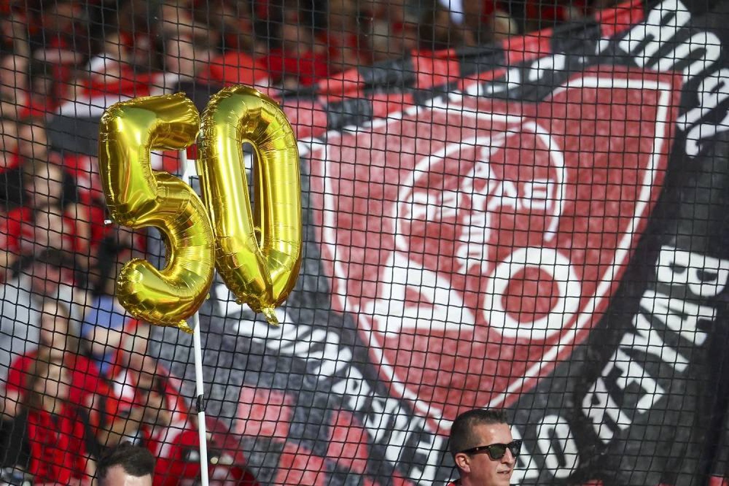 Leverkusen supporters celebrate the team being 50 matches unbeaten in all competitions this season after the German Bundesliga soccer match between VfL Bochum and Bayer Leverkusen in Bochum, Germany, 12 May 2024. (EPA)