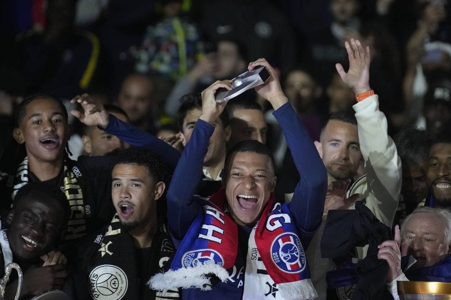 PSG's Kylian Mbappe, center, celebrates with his teammates PSG's French League One title after the French League One soccer match between Paris Saint-Germain and Toulouse at the Parc des Princes stadium in Paris, Sunday, May 12, 2024. (AP)